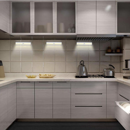 Stick on motion sensor LED light in kitchen cabinet under shelf hands free